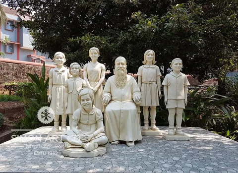 Statue group of Msgr RFC Mascarenhas seated among children, made for the Bethany Sisters