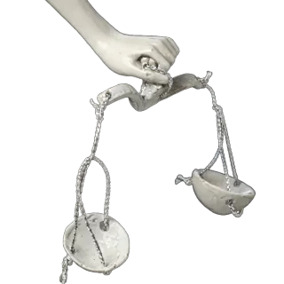 Hand of a St Michael the Archangel statue holding the scales of judgement, with silver chains and two small pans: detail of a Simon Art Co. statue
