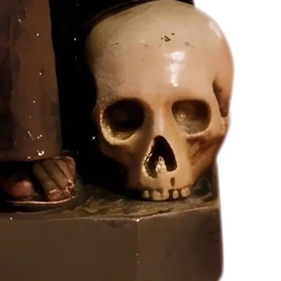 A skull at the feet of St Francis of Assisi: detail of a Simon Art Co. statue